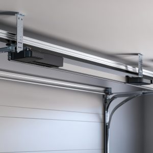 Modern garage door opener system installed on ceiling. Illustrates automated garage door functionality and convenience.